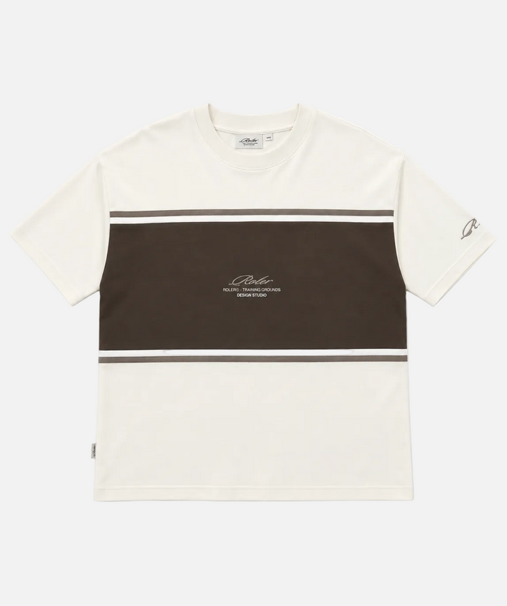 A short-sleeve crewneck t-shirt by Rolerl, featuring a colorblock design with an off-white top and bottom section and a dark brown middle band. Thin white stripes run horizontally across the chest and waist, and the brand logo is printed in the center of the brown section.